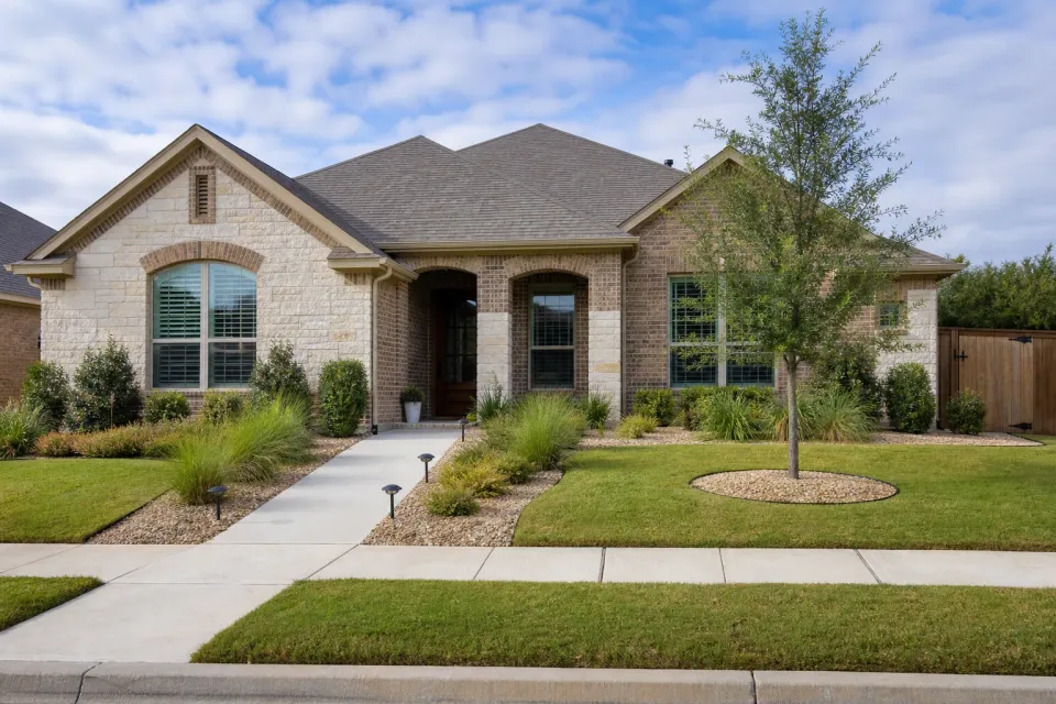 Maintained commercial-style landscape with clean rock, defined edges, healthy planting, and clear pedestrian access